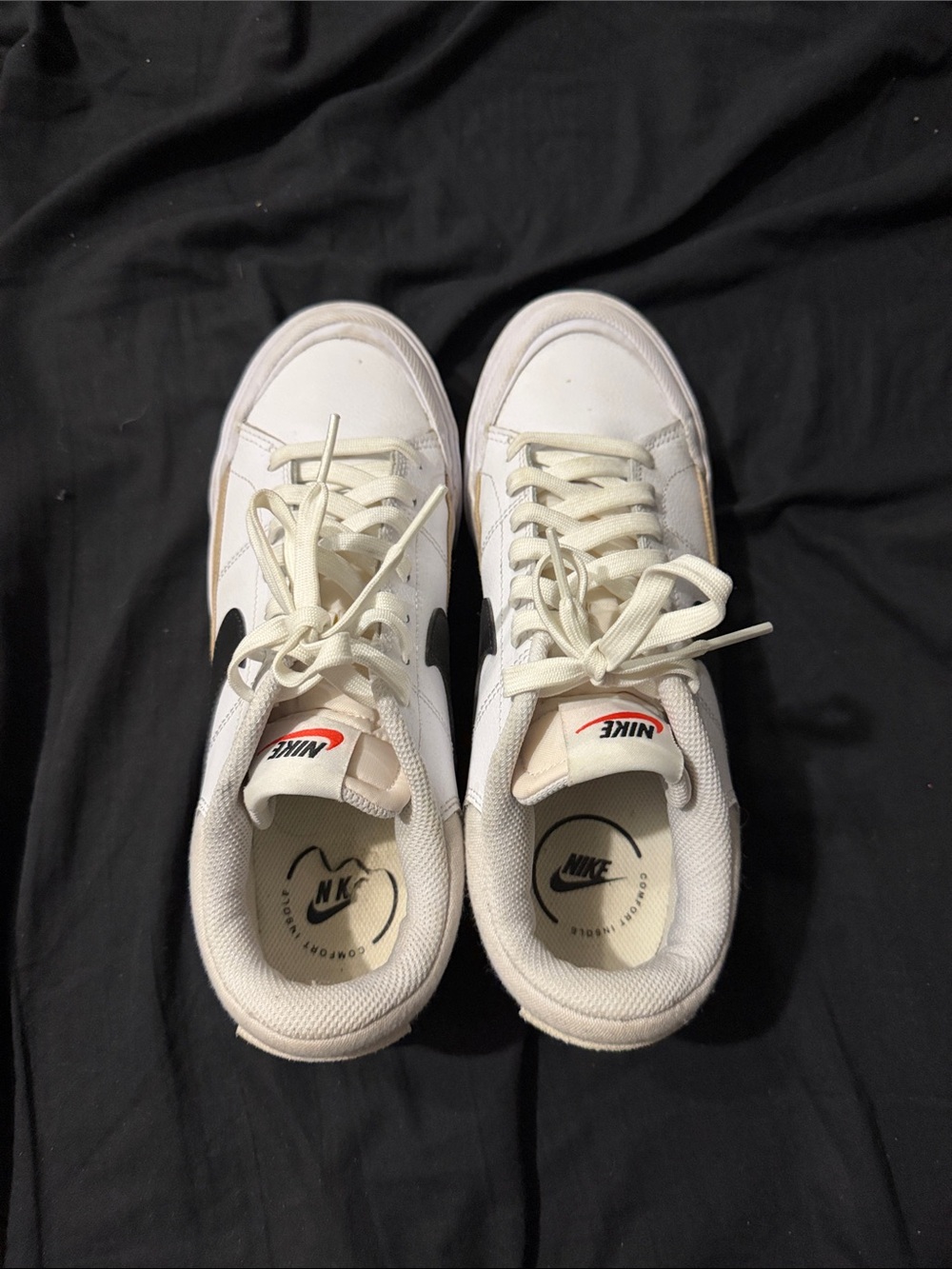 Nike White Low-Top Sneakers with Black Swoosh and Red Tongue Logo